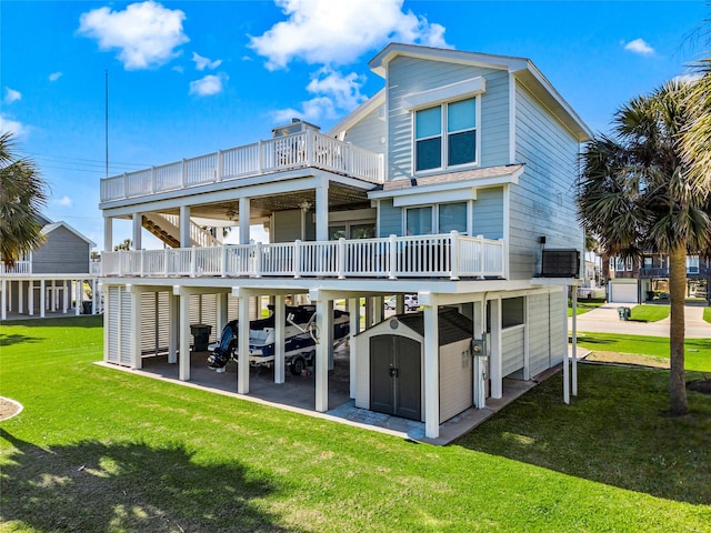 rear view of house featuring a storage unit, a balcony, an outbuilding, and a lawn