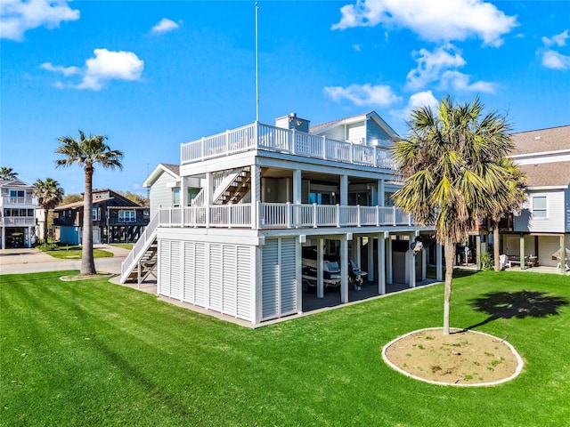 back of house with a lawn, stairs, a patio, and a wooden deck