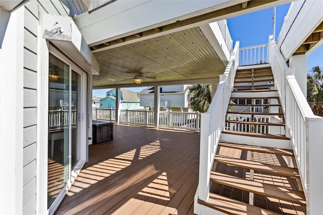 deck featuring stairway and a ceiling fan