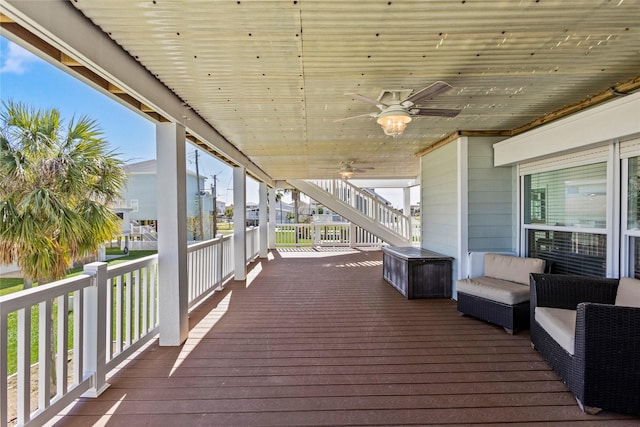 wooden terrace with a ceiling fan and stairs