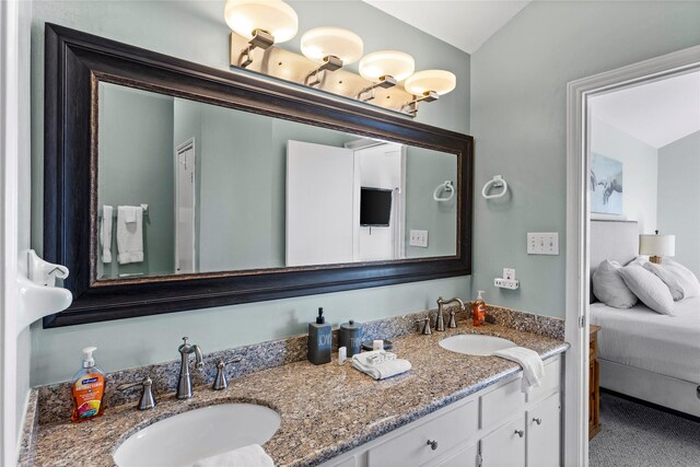 full bathroom featuring double vanity and a sink
