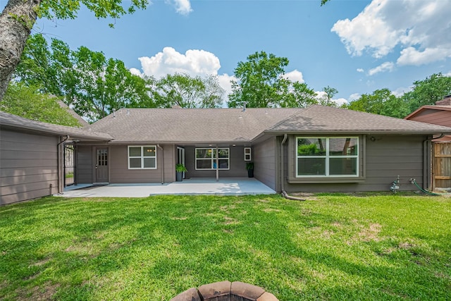 back of house with a patio, fence, and a lawn