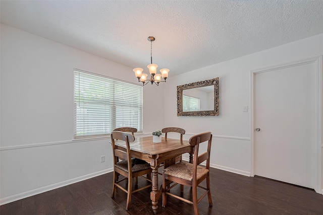 dining space featuring a chandelier, baseboards, a textured ceiling, and dark wood-style flooring
