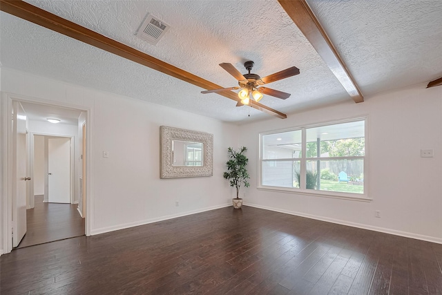 unfurnished room with beamed ceiling, dark wood-style flooring, visible vents, a ceiling fan, and a textured ceiling