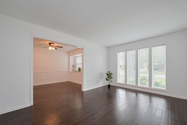 empty room featuring dark wood-style floors and baseboards