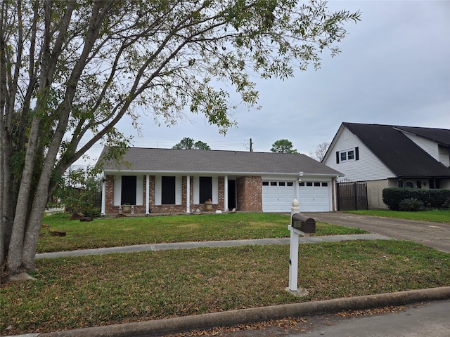 ranch-style house with brick siding, fence, aphalt driveway, a front lawn, and an attached garage
