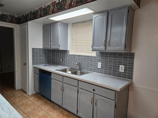 kitchen with decorative backsplash, dishwasher, light countertops, and a sink