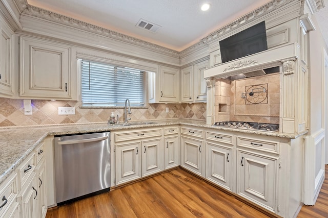 8310 Mentmore Dr, Spring, TX 77379 - kitchen with stainless steel appliances, a sink, wood finished floors, tasteful backsplash, and recessed lighting