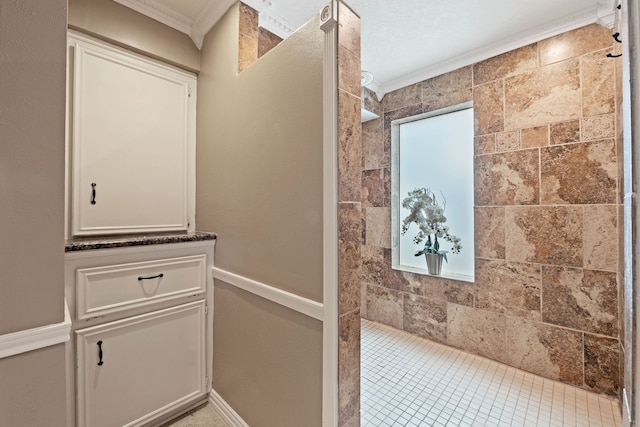 8310 Mentmore Dr, Spring, TX 77379 - full bathroom featuring ornamental molding and tiled shower