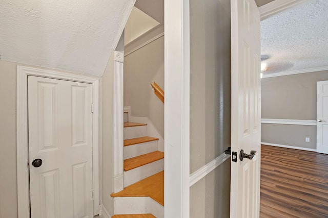 8310 Mentmore Dr, Spring, TX 77379 - staircase with a textured ceiling, wood finished floors, and baseboards