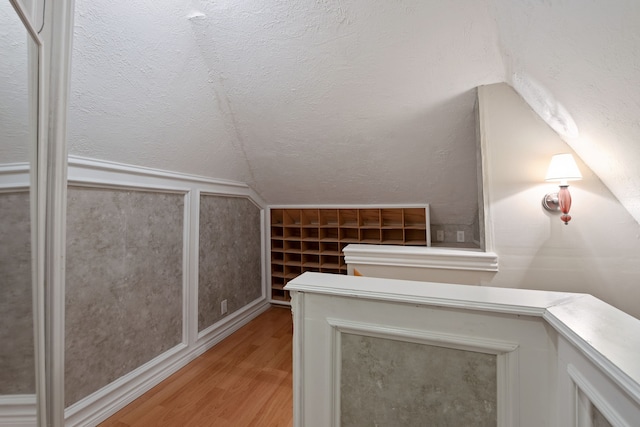 8310 Mentmore Dr, Spring, TX 77379 - additional living space featuring light wood-style flooring and vaulted ceiling