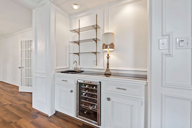 8310 Mentmore Dr, Spring, TX 77379 - indoor wet bar featuring wine cooler, crown molding, and dark wood-type flooring