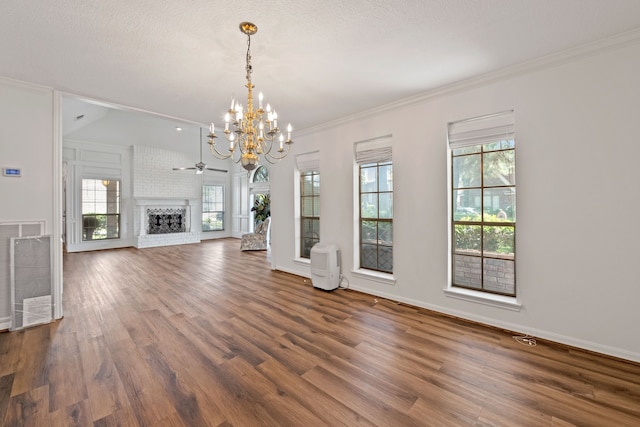 8310 Mentmore Dr, Spring, TX 77379 - unfurnished living room featuring a chandelier, wood finished floors, healthy amount of natural light, baseboards, and crown molding