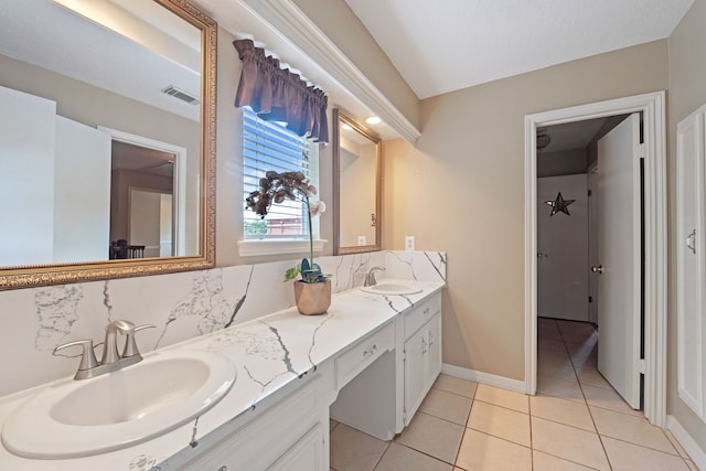 8310 Mentmore Dr, Spring, TX 77379 - bathroom featuring tasteful backsplash, tile patterned flooring, double vanity, and baseboards