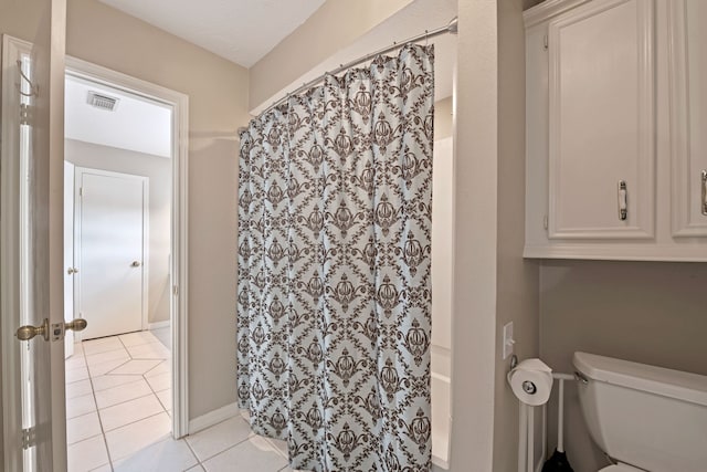 8310 Mentmore Dr, Spring, TX 77379 - full bathroom with tile patterned floors, toilet, and a shower with shower curtain