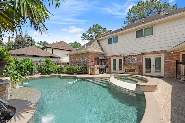 8310 Mentmore Dr, Spring, TX 77379 - view of swimming pool featuring french doors, fence, exterior kitchen, a pool with connected hot tub, and a patio area