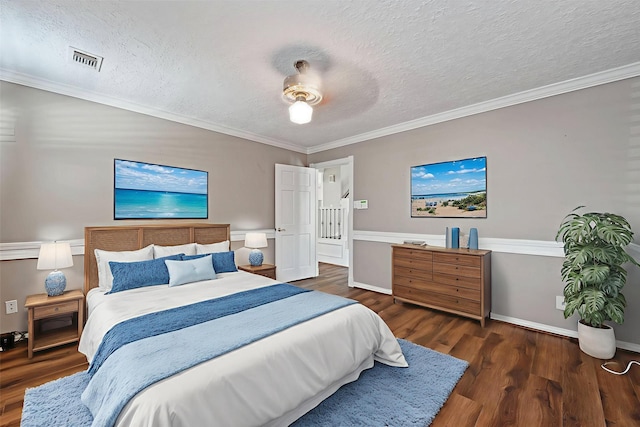 8310 Mentmore Dr, Spring, TX 77379 - bedroom featuring wood finished floors, a textured ceiling, ornamental molding, a ceiling fan, and baseboards
