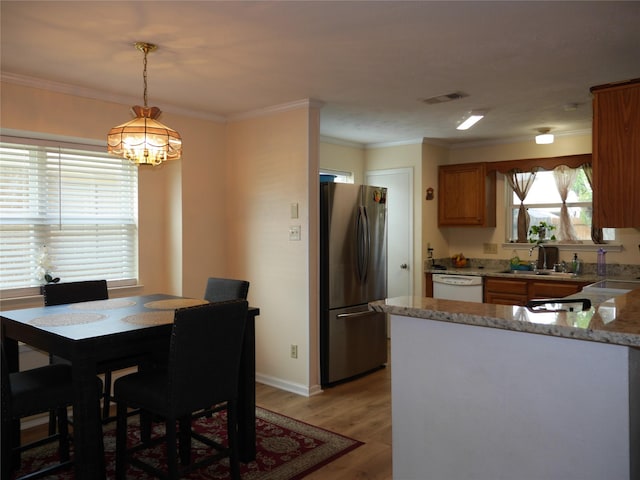 dining area with crown molding, a chandelier, baseboards, light wood-type flooring, and visible vents