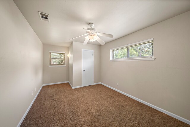 5471 Birdwood Rd, Houston, TX 77096 - unfurnished bedroom with multiple windows, baseboards, carpet, and a ceiling fan