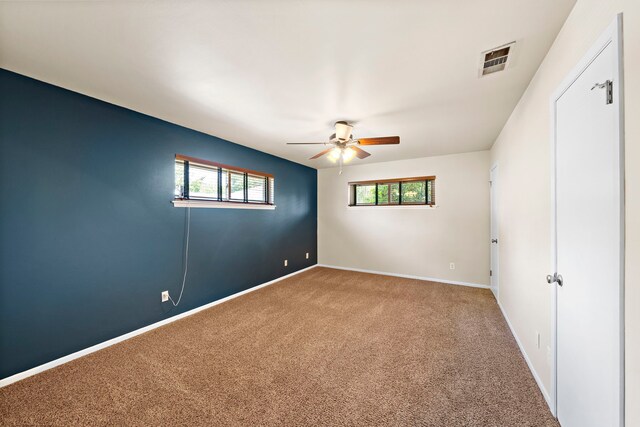 5471 Birdwood Rd, Houston, TX 77096 - unfurnished bedroom with carpet, multiple windows, baseboards, and a ceiling fan