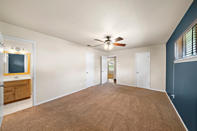 5471 Birdwood Rd, Houston, TX 77096 - unfurnished bedroom featuring light carpet, a sink, baseboards, ensuite bathroom, and a ceiling fan