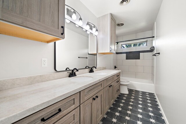 5471 Birdwood Rd, Houston, TX 77096 - bathroom with tile patterned floors, vanity, toilet, washtub / shower combination, and baseboards