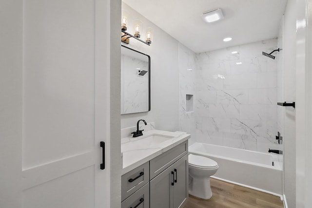 full bath featuring wood finished floors, toilet, tub / shower combination, and vanity