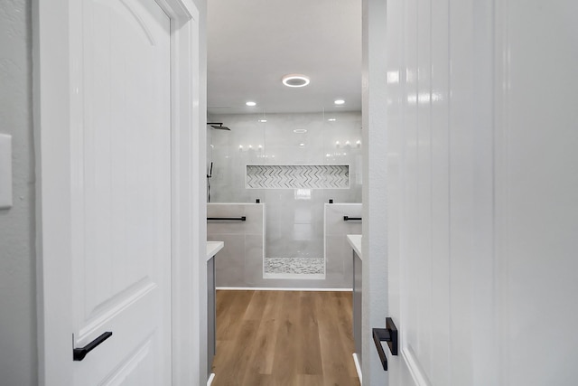 full bathroom with walk in shower, wood finished floors, and vanity