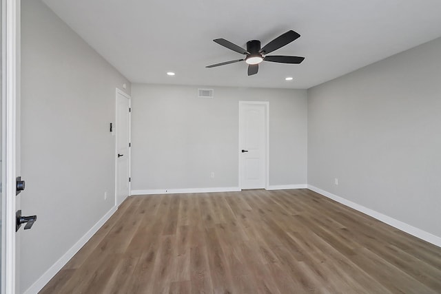 unfurnished room with baseboards, recessed lighting, wood finished floors, and a ceiling fan