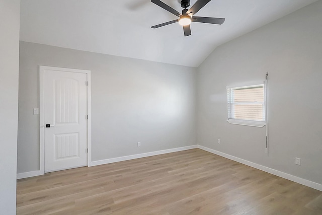 unfurnished room with baseboards, a ceiling fan, light wood-style floors, and lofted ceiling