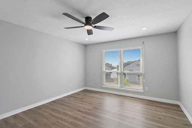 unfurnished room with recessed lighting, ceiling fan, wood finished floors, and baseboards