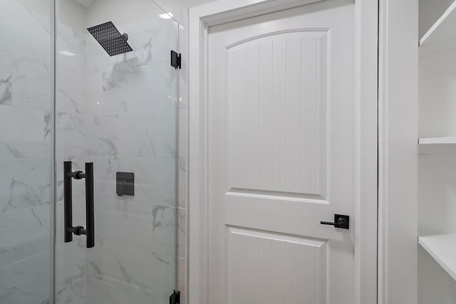full bathroom with a marble finish shower