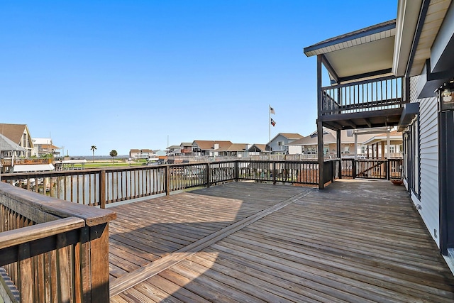 deck with a water view and a residential view