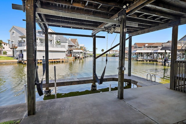 dock area with a residential view, a water view, and boat lift