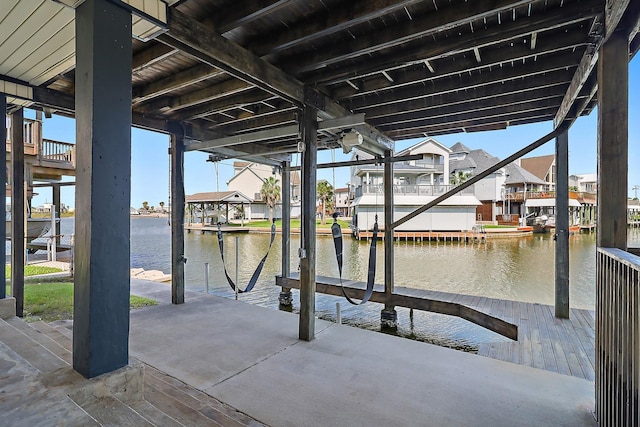 dock area featuring boat lift, a residential view, and a water view