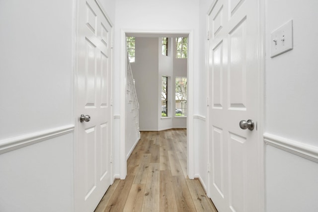 corridor featuring light wood finished floors