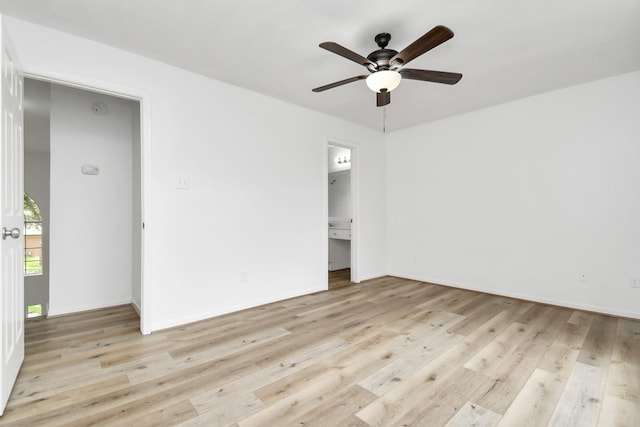 empty room with baseboards, wood finished floors, and ceiling fan