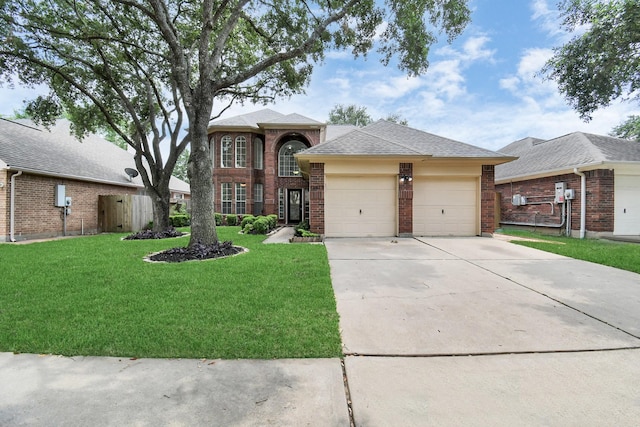 traditional home with brick siding, a shingled roof, a front yard, concrete driveway, and an attached garage