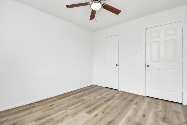 unfurnished bedroom with baseboards, a ceiling fan, and light wood finished floors