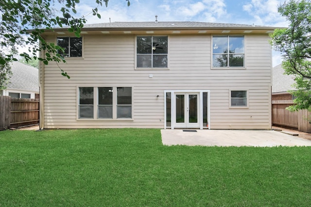 rear view of property with a lawn, french doors, a fenced backyard, and a patio area
