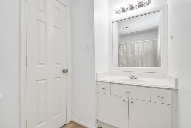 bathroom with baseboards, visible vents, and vanity