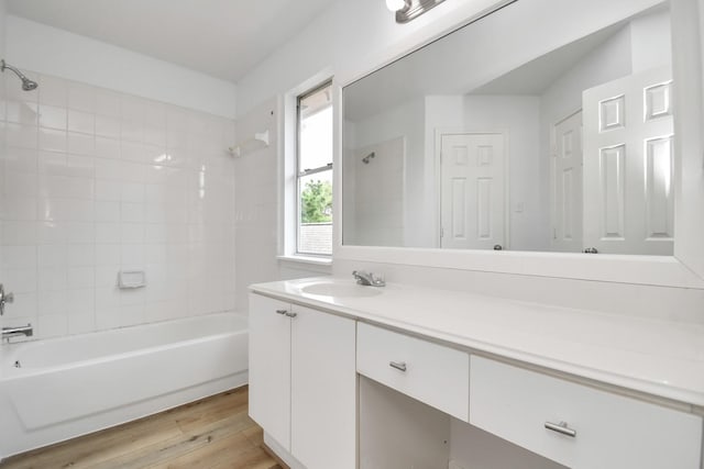 full bathroom featuring wood finished floors, vanity, and shower / bathtub combination