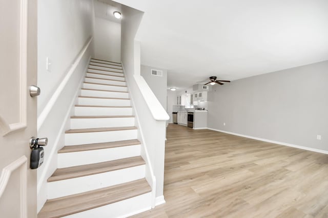 2207 Bauer Dr Unit A, Houston, TX 77080 - staircase featuring a ceiling fan, wood finished floors, and baseboards