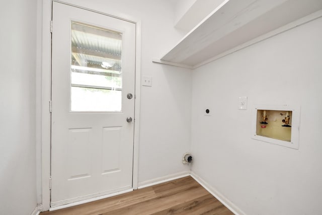 2207 Bauer Dr Unit A, Houston, TX 77080 - washroom with hookup for an electric dryer, washer hookup, wood finished floors, and baseboards