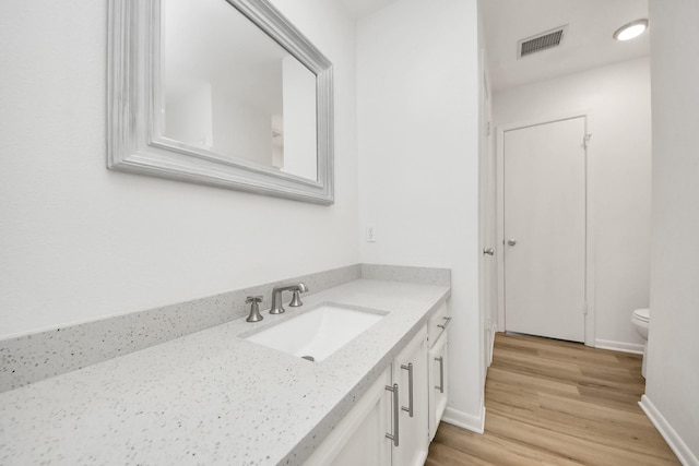 2207 Bauer Dr Unit A, Houston, TX 77080 - bathroom with vanity, wood finished floors, toilet, and baseboards