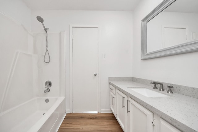 2207 Bauer Dr Unit A, Houston, TX 77080 - bathroom with vanity, wood finished floors, and washtub / shower combination