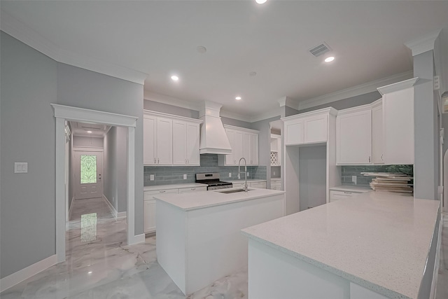 403 Smith St, Dayton, TX 77535 - kitchen with crown molding, stainless steel range, a sink, custom range hood, and visible vents