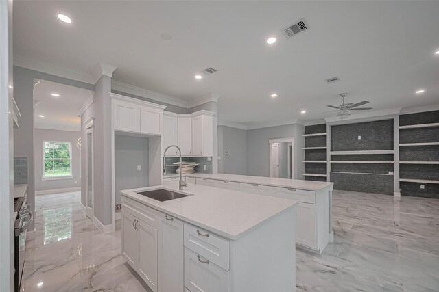 403 Smith St, Dayton, TX 77535 - kitchen featuring a sink, light marble finish flooring, ornamental molding, an island with sink, and a ceiling fan