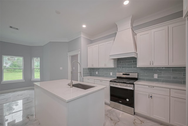 403 Smith St, Dayton, TX 77535 - kitchen with visible vents, stainless steel gas stove, a sink, premium range hood, and marble finish floor