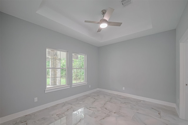 403 Smith St, Dayton, TX 77535 - unfurnished room featuring a ceiling fan, visible vents, baseboards, marble finish floor, and a tray ceiling